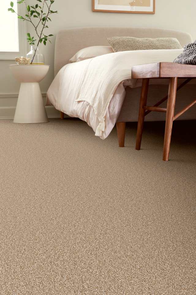 cozy plush carpet in all natural bedroom with wood accents and greenery